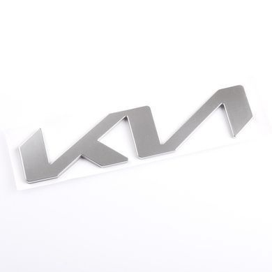 Купити Емблема-напис Kia NEW GRAY 130x30 мм металева на скотчі (заводська) 88583 Емблема напис на іномарки