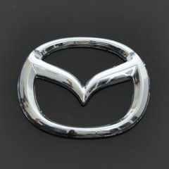 Купить Эмблема для Mazda 626 / 323 пластиковая 63 x 50 мм 21366 Эмблемы на иномарки