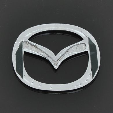 Купити Емблема Mazda 626 / 323 пластик 63х50 мм 21366 Емблеми на іномарки