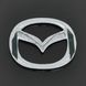 Купити Емблема Mazda 626 / 323 пластик 63х50 мм 21366 Емблеми на іномарки - 2 фото из 2